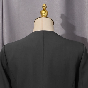 Detail of the back stitching and fine texture on a dark grey tailored blazer