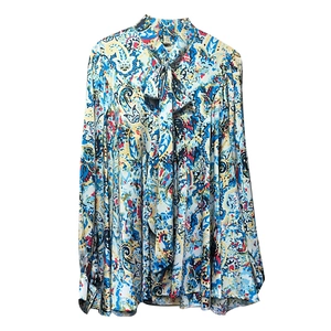 Detail of pussy-bow tie neck and vintage paisley print on women's long sleeve shirt