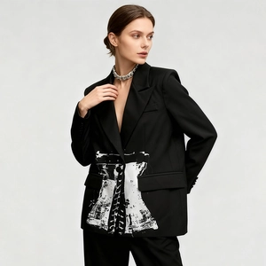 Detailed view of women's black blazer with white corset print and metal chain necklace