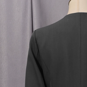 Detail of the shoulder seam and back stitching on a tailored black blazer for women