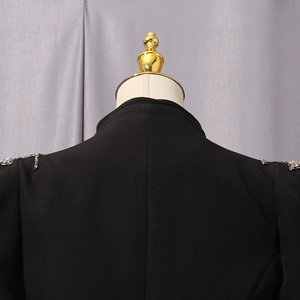 Close-up of black slim fit blazer with handcrafted rhinestone and sequin shoulder details