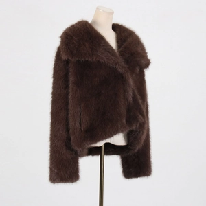 Detail shot of dense dark brown faux fur texture and wide lapel on short winter coat