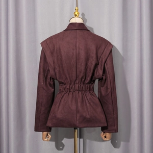 Detail of the elastic shirred waist and hemline on this dark brown suede jacket