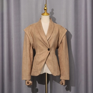 Detail of khaki waist-accentuated jacket featuring unique double-layered silhouette shoulders