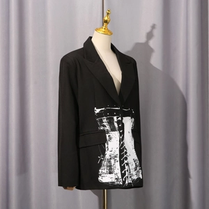Detail of black fitted blazer featuring unique white corset style graphic print on the front