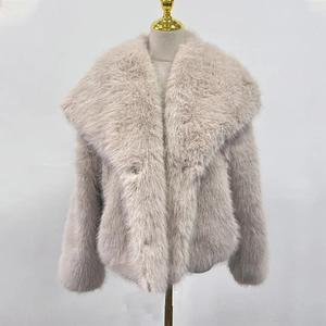 Close-up of fluffy faux fur texture and wide collar on light pink short coat