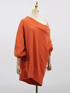 Oversized orange off-shoulder knit sweater with ribbed cuffs and textured wool fabric