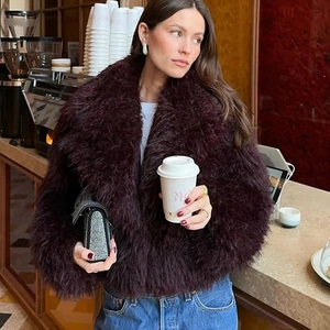 Detailed texture of fluffy deep burgundy faux fur jacket with stylish plush finish