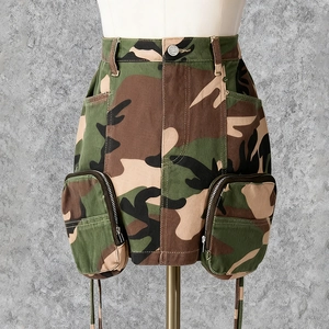 Detailed view of cargo camo mini skirt featuring large utility pockets and metal zippers