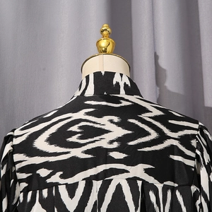 Detail of contrast geometric print shirt featuring standard collar and back seam stitching