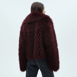 Macro view of the back texture of a burgundy long-pile faux fur jacket with glossy fibers