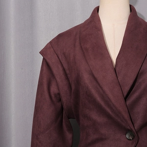 Close-up of deep burgundy faux suede jacket showing fabric texture and button detail