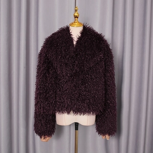 Detailed texture of dark purple faux fur coat with elegant thick long hair material