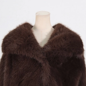 Close-up of deep brown faux fur coat showing thick plush texture and wide collar detail