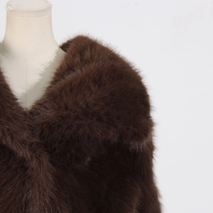 Detail of premium faux fur texture on brown lapel coat with lush soft material