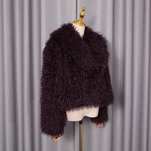 Detail of deep purple faux fur jacket showing shaggy texture and large lapel design