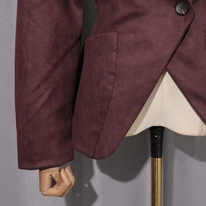 Detailed shot of dark purple suede jacket showing single button and flap pocket texture