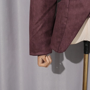 Detailed stitching on cuffs and hem of a dark burgundy suede jacket on a mannequin