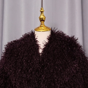 Detailed view of deep purple faux fur jacket texture on a professional mannequin