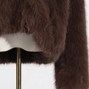 Close-up of luxury dark brown faux fur jacket with dense soft texture and shiny finish