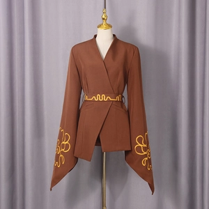 Detail of brown blazer with yellow wavy embroidery on flared sleeves and matching waist belt