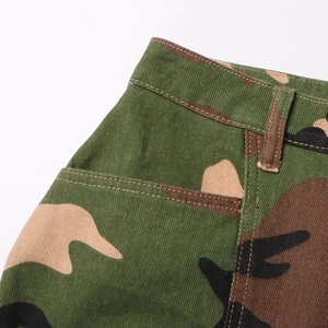 Detailed macro view of camo mini skirt showing waistband, belt loops and side pockets