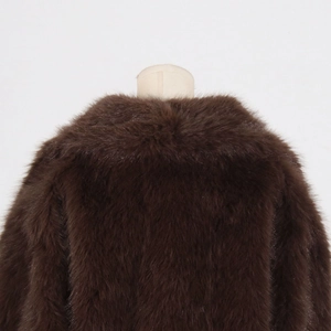 Detail view of smooth dark brown faux fur texture and lapel collar on the coat