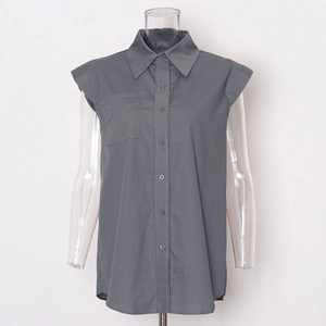 Detail view of dark grey sleeveless shirt with classic collar and front pocket
