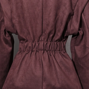 Detailed view of elastic gathered waist and wine red suede fabric on the short jacket
