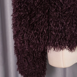 Close-up of luxury deep purple faux fur jacket texture with soft plush faux fur material