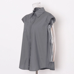 Detail view of grey sleeveless shirt featuring classic collar and chest pocket design