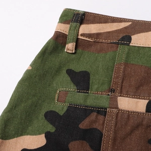 Detailed view of camouflage skirt waist featuring reinforced belt loops and twill texture