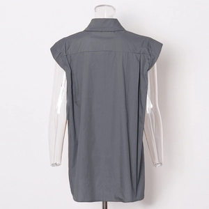 Detail view of the back of a dark gray sleeveless shirt with a sharp wide shoulder cut