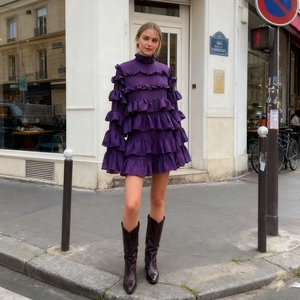 Detail of a deep purple tiered ruffle mini dress with high collar and layered waves