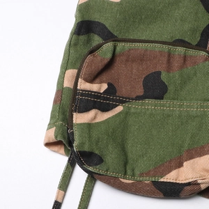 Detail of camouflage twill skirt featuring functional cargo pocket and drawstring hemline