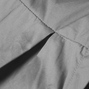 Macro shot showing high-quality gray fabric texture and neat sewing stitching on the top