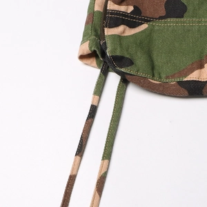 Detailed close-up of camouflage fabric texture and drawstring design on street style skirt