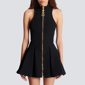 Detail of black high-neck sleeveless dress with gold zipper and embossed design