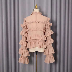 Detail view of the layered ruffles and back zipper on this dusty pink chiffon blouse
