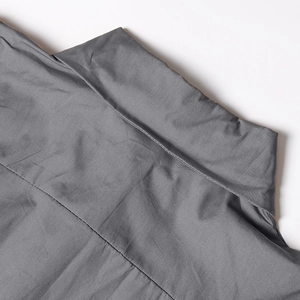 Detailed view of the collar and shoulder stitching on a grey sleeveless blouse