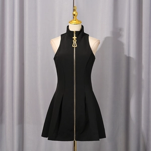 Detail of a black sleeveless turtleneck dress with a gold geometric zipper slider