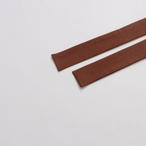 Close-up of deep brown fabric belts with detailed texture for modern women's blazers