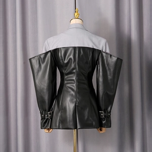 Close-up of patchwork grey blazer with black PU leather sleeves and metal buckle detail