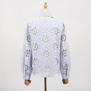 Detail of light blue striped shirt featuring intricate hollow floral lace on back