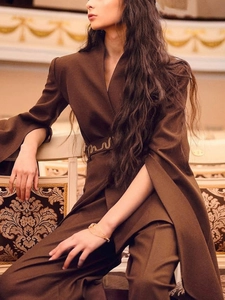 Women's dark brown split-sleeve blazer suit with gold metallic belt and slim pants