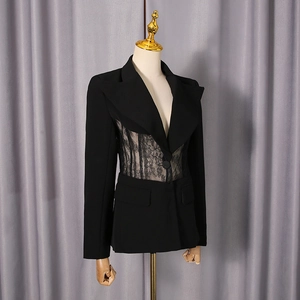 Detail of sheer lace waist panel on black slim-fit blazer with single-button closure
