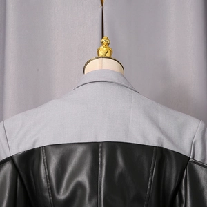 Detail view of the back showing light grey woven fabric stitched with black leather material