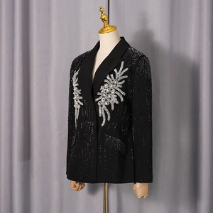 Detail of floral embroidery, pearls and rhinestones on black tailored blazer jacket