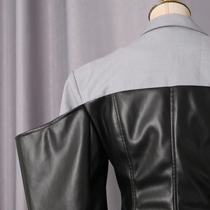 Close-up of contrast patchwork design with grey fabric and black faux leather on the back