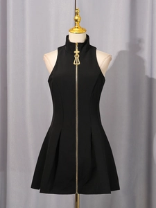Sleeveless black mini dress featuring a full-length golden zipper and cross pendant